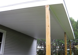 Stick built car port attached to a garage